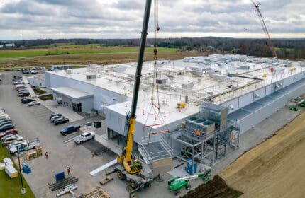 Equipment Installation by Two Cranes during Food and Beverage Facility Construction