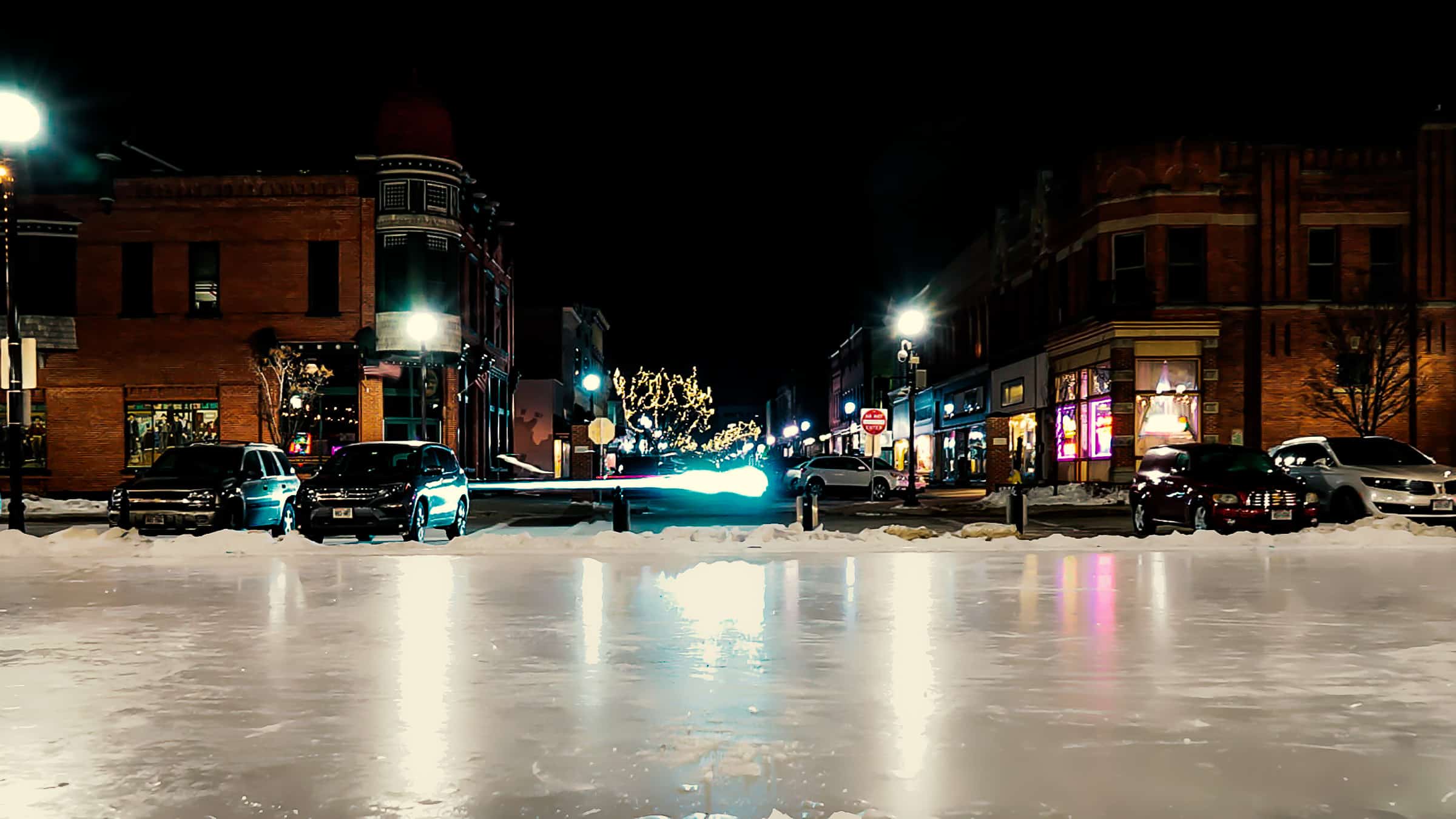 Downtown Stevens Point at night in the winter with ice rink in the center square