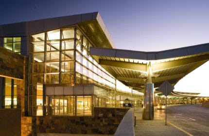 Will Rogers World Airport - Exterior View at Dusk with Covered Entrance/Exit for Passenger Pick-ups/Drop-offs
