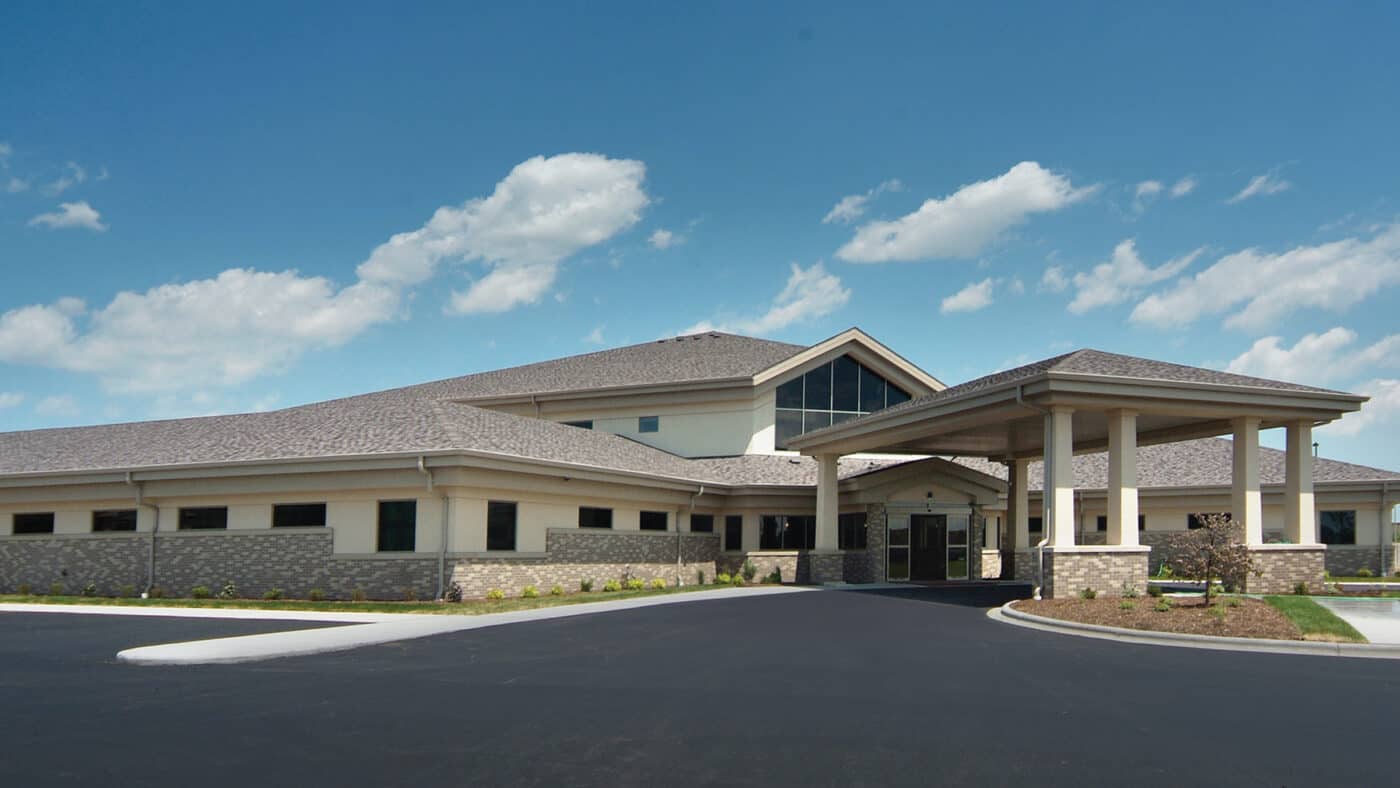 Primary Care Associates - Exterior of Building with Circle Drive, Parking Lot, Covered Entrance from Angle