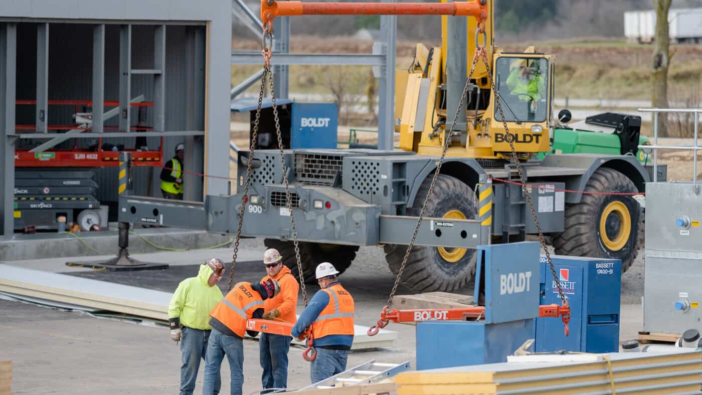 Salm Partners - Exterior Construction Vehicle and 4 Workers Prepare for Lift