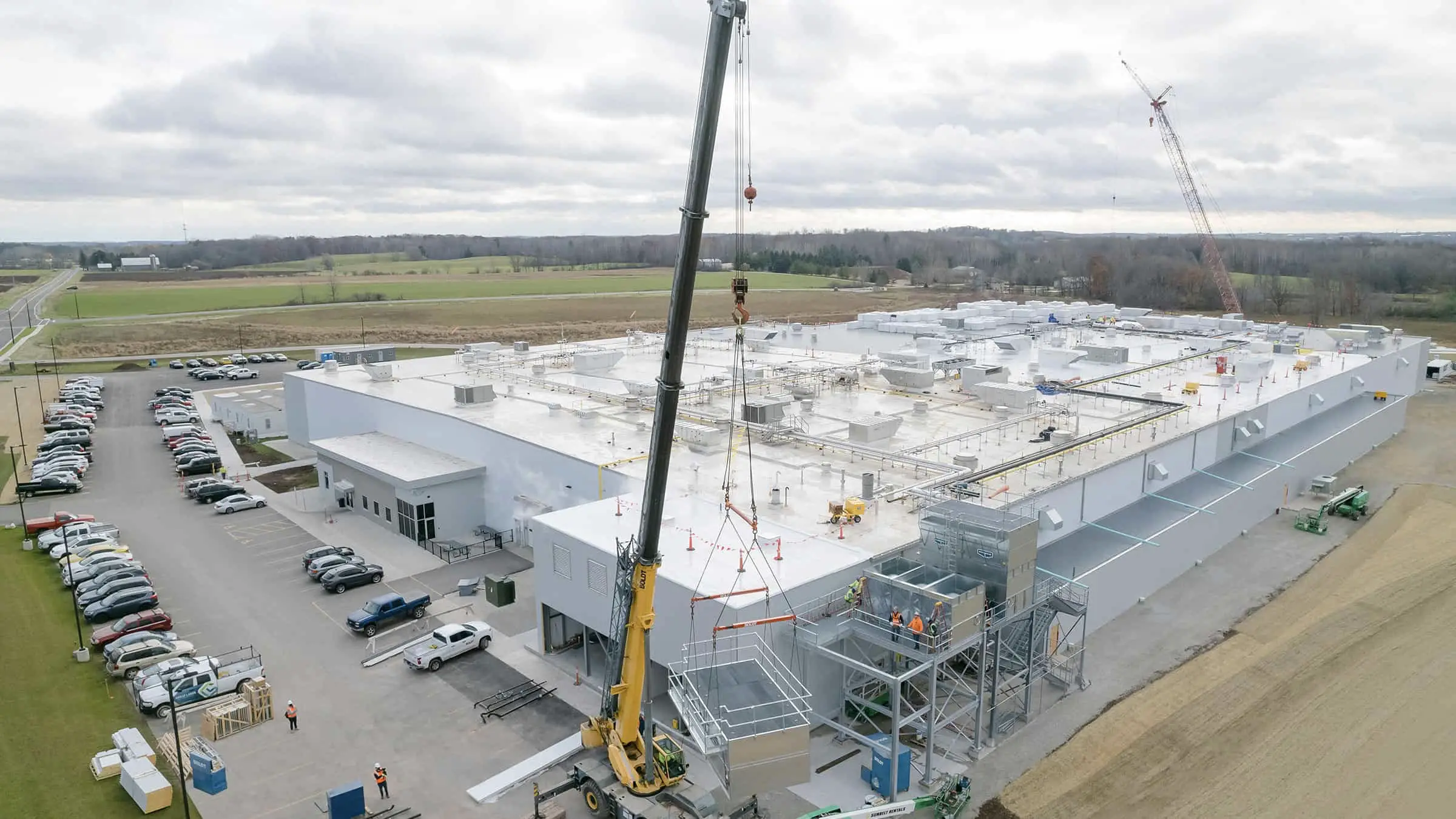 Salm Partners Meat Processing Plant - Aerial View as Construction Crane Lifts Equipment into Place