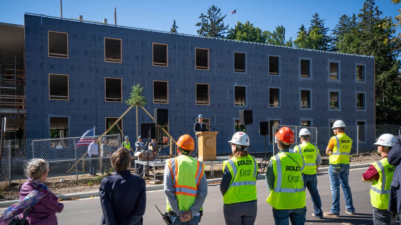 St. Olaf College - Residence Hall Construction Event with Boldt Employees and Other Attendees in Foreground during Program