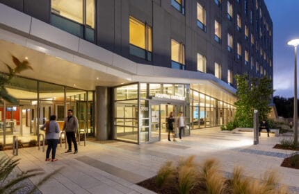 Sutter Health - CPMC - Mission Bernal Campus Hospital Exterior Entrance Lit at Night